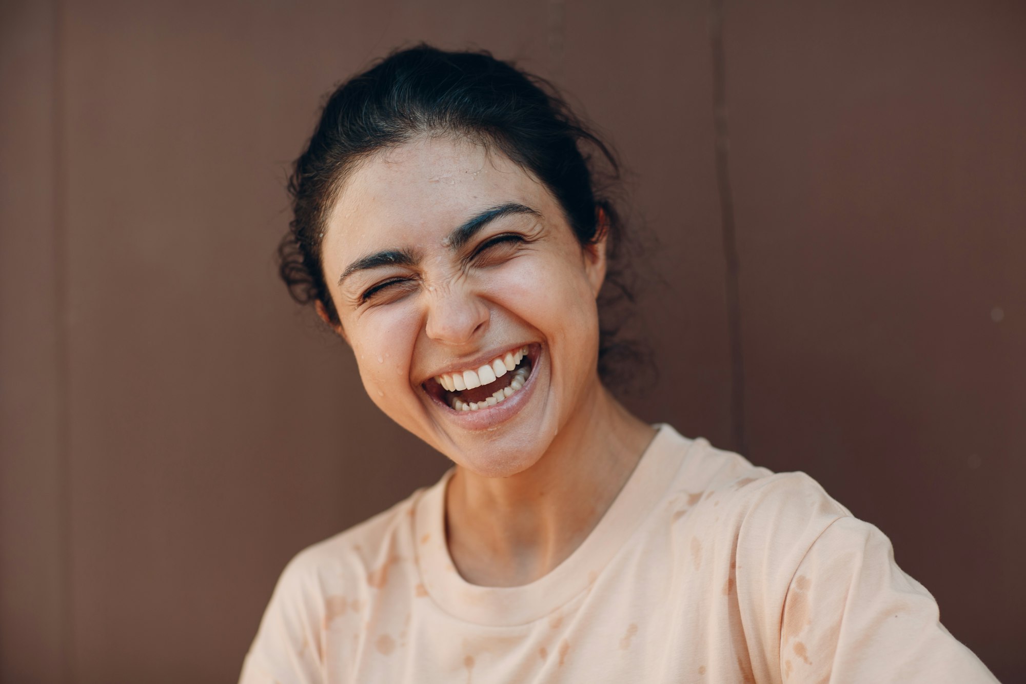 Indian woman laughing at city outdoor portrait